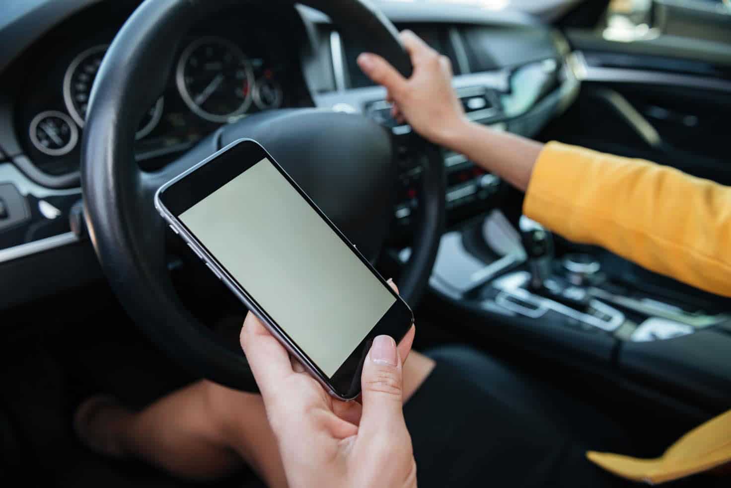 young-woman-driver-using-touch-screen-smartphone.jpg